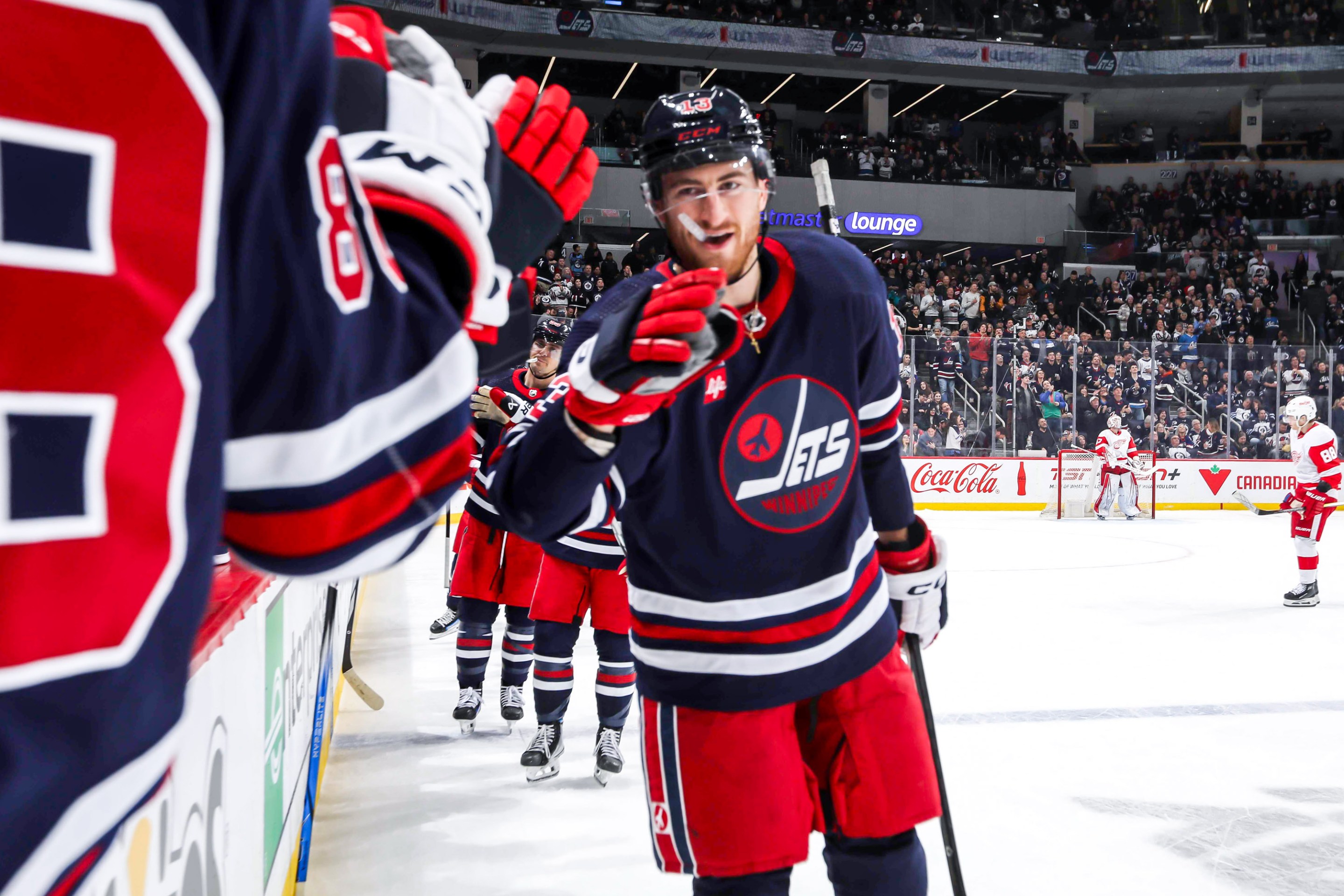 Gabriel Vilardi #13 of the Winnipeg Jets celebrates his second period goal against the Detroit Red Wings with teammates at the bench at the Canada Life Centre on December 20, 2023 in Winnipeg, Manitoba, Canada.