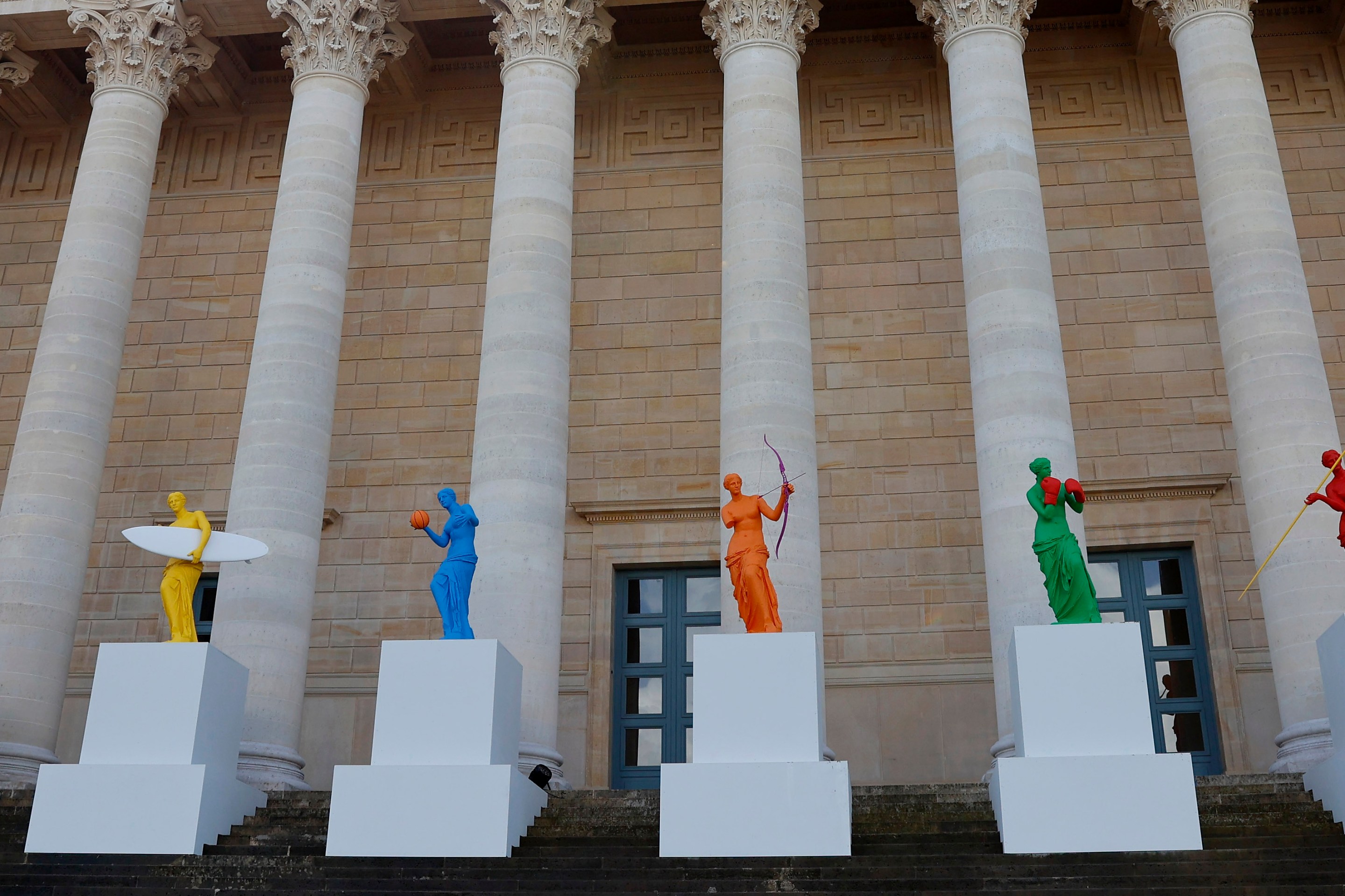 PARIS, FRANCE - APRIL 04: "La Beaute et le Geste" exhibition by French Artist Laurent Perbos is displayed in front of the French National assembly ahead of the Paris 2024 Olympic Games on April 04, 2024 in Paris, France. On the occasion of the Paris 2024 Olympic and Paralympic Games, the National Assembly celebrates sport by welcoming the visual artist Laurent Perbos and his 6 metamorphosed Venus de Milo. A universally known work, the Venus here finds her arms and is endowed attributes of six sporting disciplines: tennis, surfing, para archery, basketball, boxing and javelin throwing. (Photo by Chesnot/Getty Images)