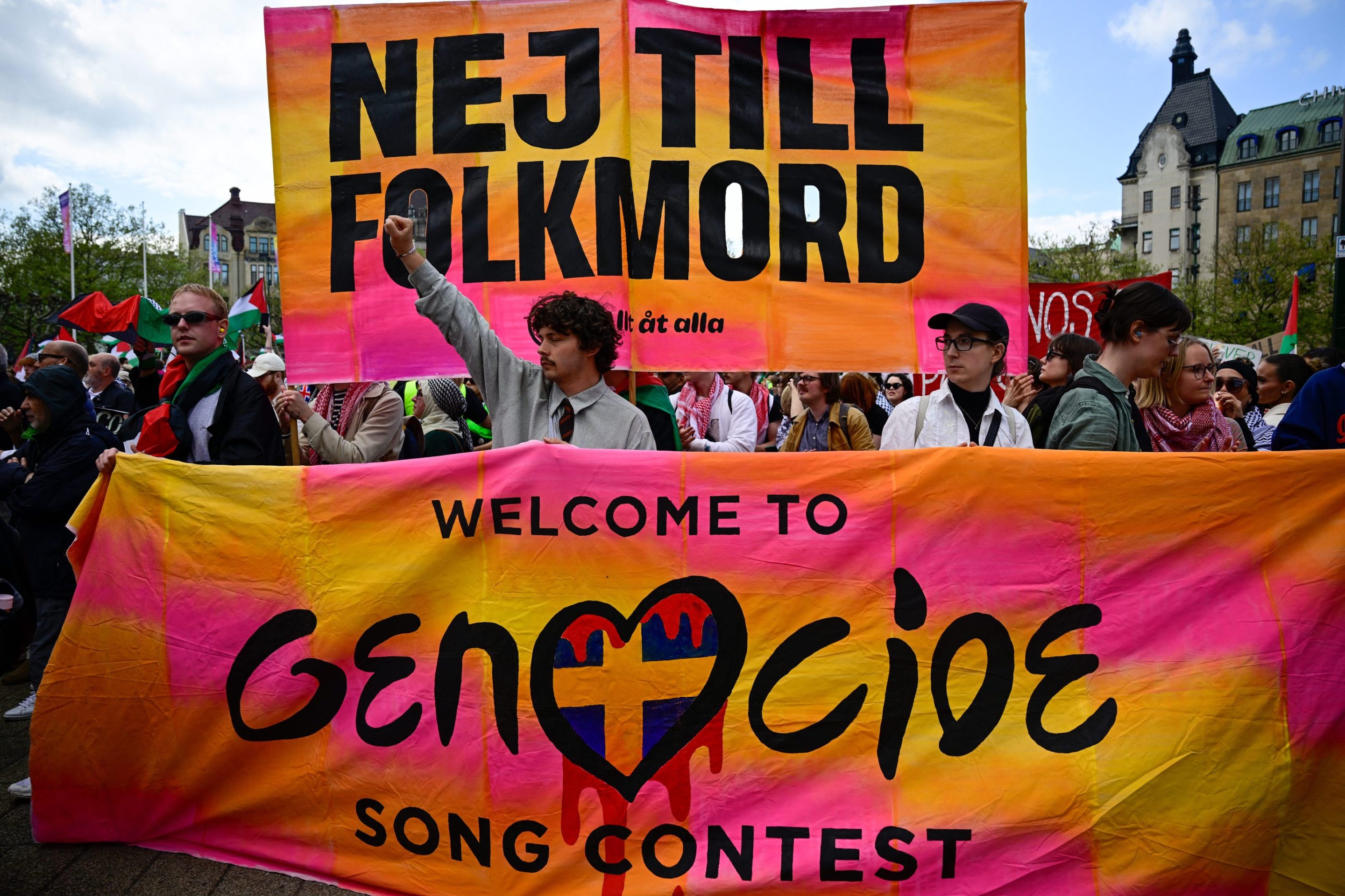 Pro-Palestinian protesters opposing Israel's participation in the 68th edition of the Eurovision Song Contest (ESC) demonstrate in Malmo, Sweden, on May 11, 2024, with a poster saying : NEJ TILL FOLKMORD, Welcome to the Genocide Song Contest