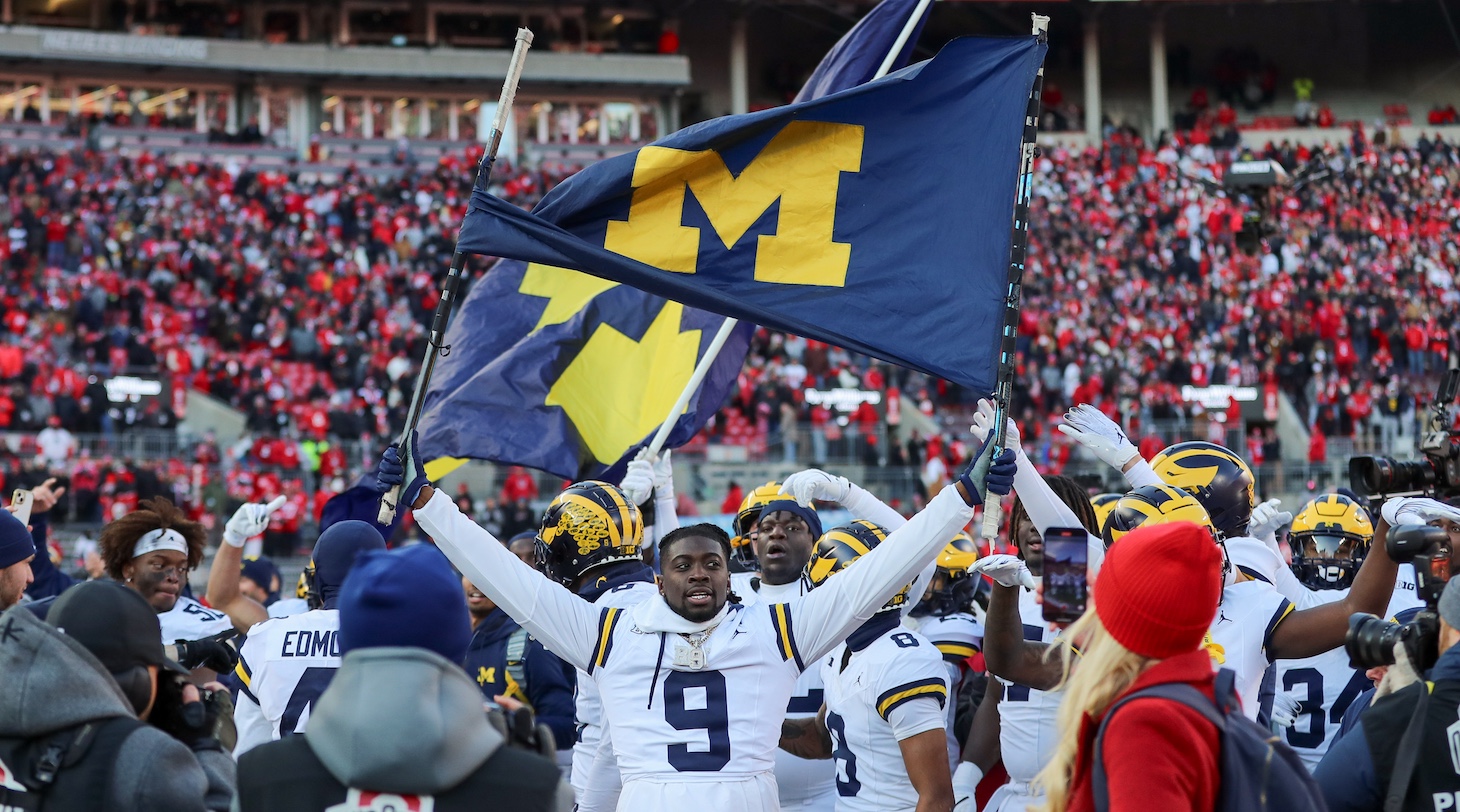 Michigan Wolverines defensive back Rod Moore (9) walks on the field holding a Michigan flag with his teammates after the game against the Michigan Wolverines and the Ohio State Buckeyes on November 30, 2024, at Ohio Stadium in Columbus, OH.