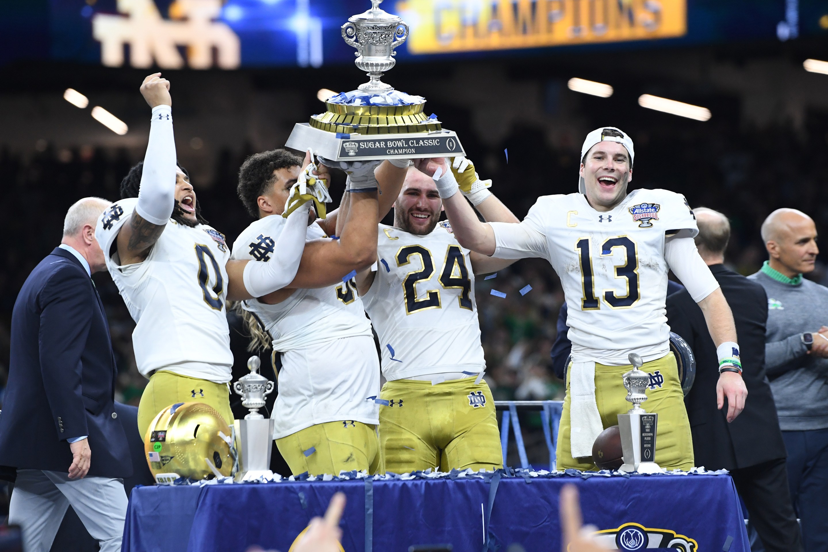 Safety Xavier Watts #0 of the Notre Dame Fighting Irish, Defensive Lineman Howard Cross III #56 of the Notre Dame Fighting Irish, Linebacker Jack Kiser #24 of the Notre Dame Fighting Irish and Quarterback Riley Leonard #13 of the Notre Dame Fighting Irish hoist the Allstate Sugar Bowl trophy after the Notre Dame Fighting Irish versus Georgia Bulldogs College Football Playoff Quarterfinal at the Allstate Sugar Bowl on January 2, 2025.
