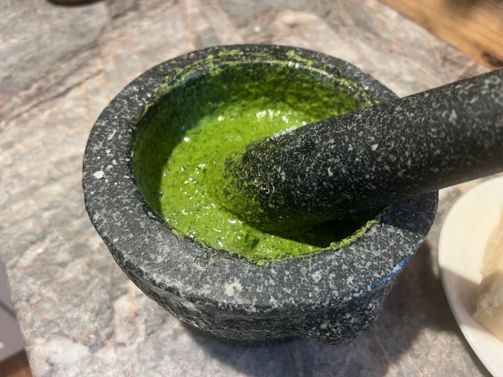 Green pesto in a mortar.