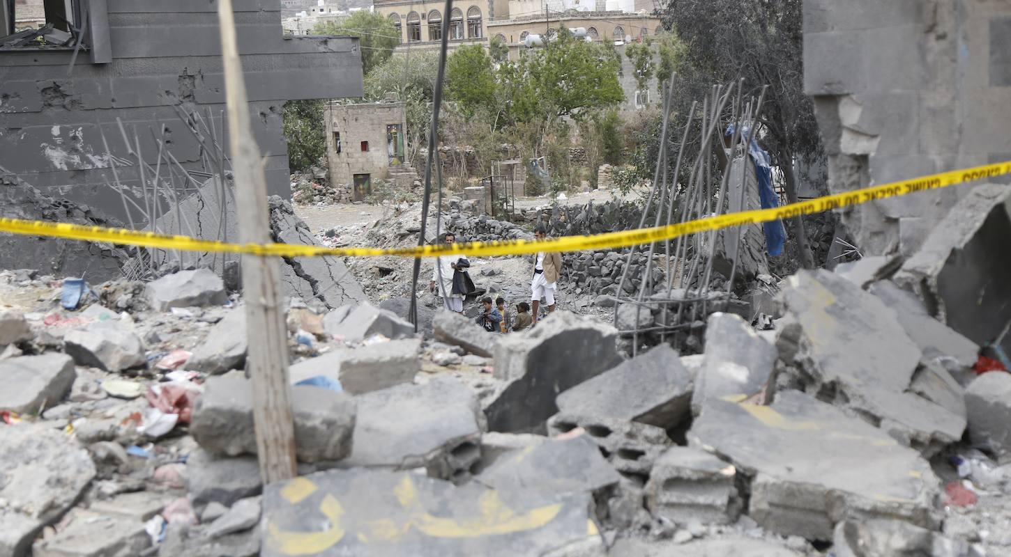 Yemeni men and children in the rubble of a Sana'a neighborhood leveled by U.S. attacks.