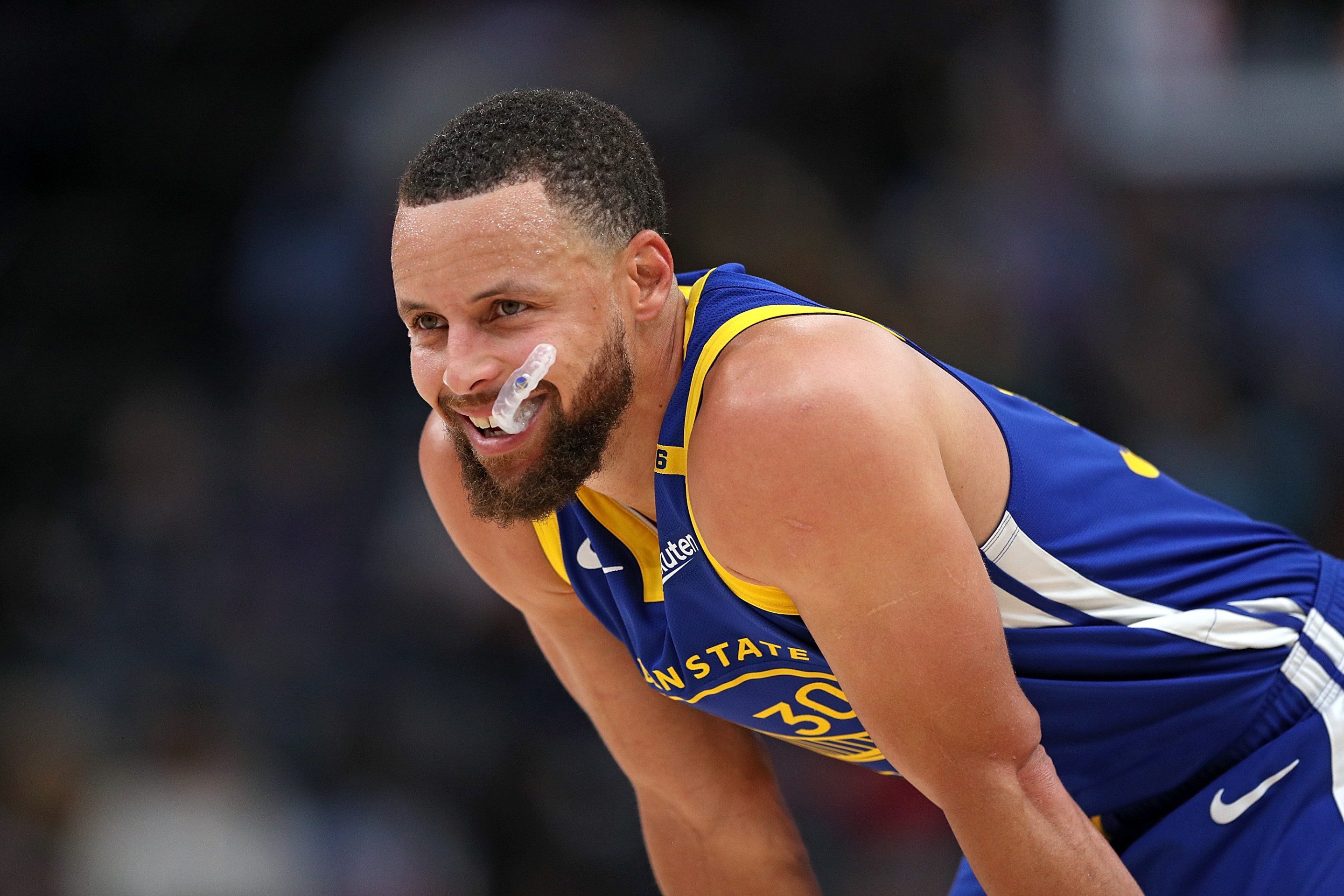 looks on during the first half against the Memphis Grizzlies on April 1, 2025. His mouthpiece is hanging out of his mouth and he looks faintly sinister in how delighted he seems.