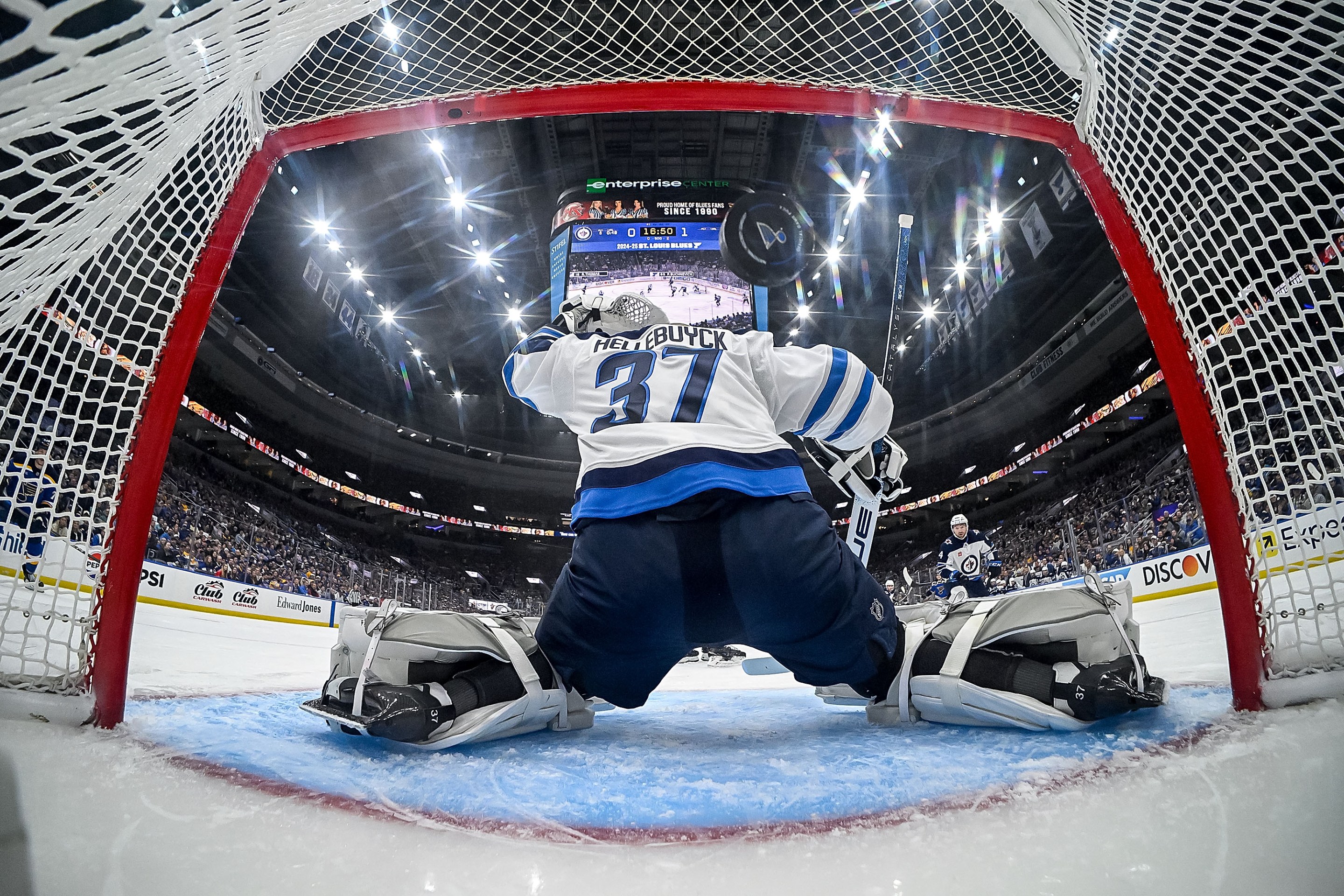 ST. LOUIS, MO - APRIL 24: Connor Hellebuyck #37 of the Winnipeg Jets gives up a goal to the St. Louis Blues in the first period of Game Three of the First Round of the 2025 Stanley Cup Playoffs on April 24, 2025 at the Enterprise Center in St. Louis, Missouri. (Photo by Scott Rovak/NHLI via Getty Images)